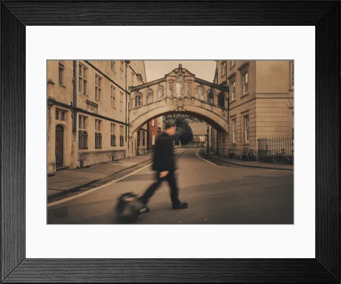 Framed Print : A tourist walking past the Bridge of Sighs in Oxford Framed Print : A tourist walking past the Bridge of Sighs in Oxford