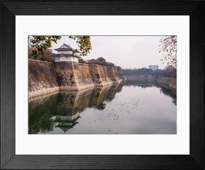 Framed Print : Osaka Castle in Japan. Overlooking the stone moat and reflecting water at Rokuban-yagura Turret on the outer walls.Framed by late autumanl foliage Framed Print : Osaka Castle in Japan. Overlooking the stone moat and reflecting water at Rokuban-yagura Turret on the outer walls.Framed by late autumanl foliage