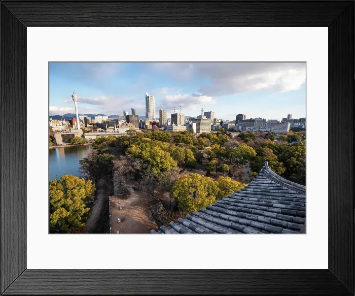 Framed Print : Skyline of Hiroshima with the area of the castle Park in the Foreground. Looking over the Samurai Castle roofs. Evening light and tree tops Framed Print : Skyline of Hiroshima with the area of the castle Park in the Foreground. Looking over the Samurai Castle roofs. Evening light and tree tops