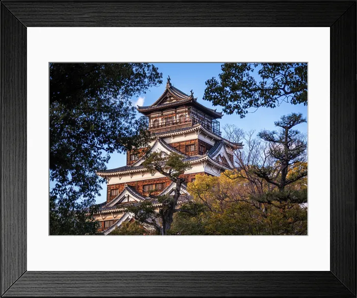 Framed Print : The Main Keep of Hiroshima Castle against a blue sky. Framed by Lush trees in the foreground. Hiroshima, Japan Framed Print : The Main Keep of Hiroshima Castle against a blue sky. Framed by Lush trees in the foreground. Hiroshima, Japan