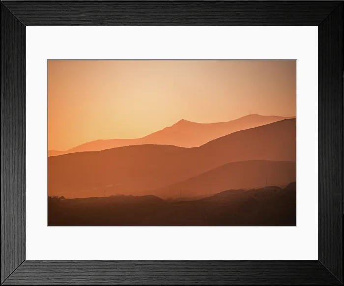 Framed Print : Golden hues blanket the rolling mountains of AlmerAa, Spain, as the setting sun creates a dreamy, layered silhouette effect Framed Print : Golden hues blanket the rolling mountains of AlmerAa, Spain, as the setting sun creates a dreamy, layered silhouette effect