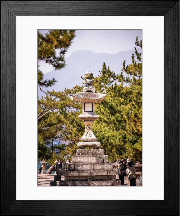 Framed Print : Tall stone lantern in front of warm green Trees. Japan Framed Print : Tall stone lantern in front of warm green Trees. Japan
