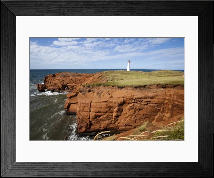 Framed Print : Red sandstone cliff and lighthouse on Cap-aux-Meules Island on the Iles de la Madeleine Framed Print : Red sandstone cliff and lighthouse on Cap-aux-Meules Island on the Iles de la Madeleine