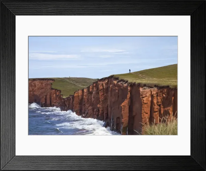Framed Print : Person walking on red sandstone cliff on Cap-aux-Meules Island in the Iles de la Madeleine Framed Print : Person walking on red sandstone cliff on Cap-aux-Meules Island in the Iles de la Madeleine
