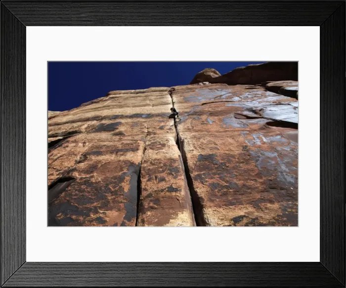 Framed Print : A rock climber tackles an overhanging crack in a sandstone wall on the cliffs of Indian Creek Framed Print : A rock climber tackles an overhanging crack in a sandstone wall on the cliffs of Indian Creek