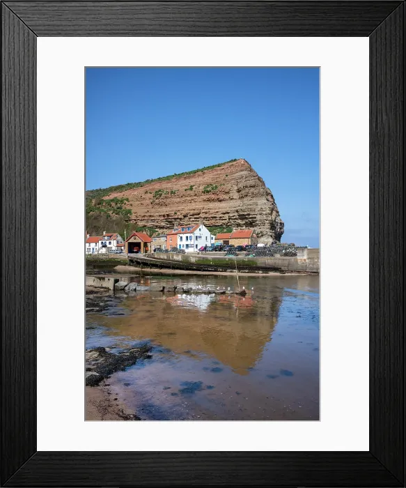 Framed Print : Houses nestled under the high cliffs in the small fishing village of Staithes, Yorkshire, United Kingdom Framed Print : Houses nestled under the high cliffs in the small fishing village of Staithes, Yorkshire, United Kingdom