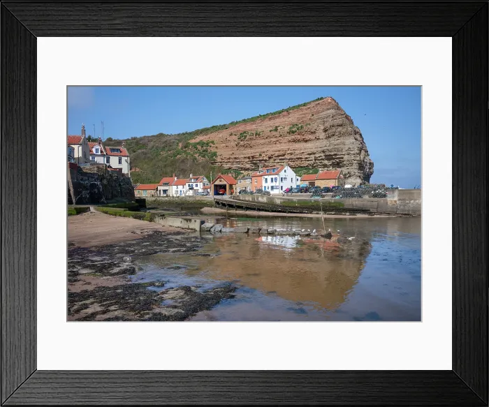 Framed Print : Houses nestled under the high cliffs in the small fishing village of Staithes, Yorkshire, United Kingdom Framed Print : Houses nestled under the high cliffs in the small fishing village of Staithes, Yorkshire, United Kingdom