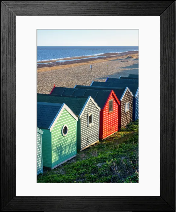 Framed Print : A row of colourful beach huts on the beach at Southwold in the county of Suffolk, United Kingdom Framed Print : A row of colourful beach huts on the beach at Southwold in the county of Suffolk, United Kingdom