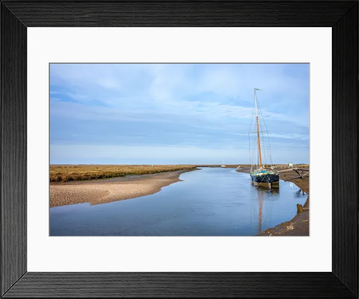 Framed Print : Moored yacht on the banks of the River Glaven, with marshes beyond, at Blakeney in North Norfolk, United Kingdom Framed Print : Moored yacht on the banks of the River Glaven, with marshes beyond, at Blakeney in North Norfolk, United Kingdom