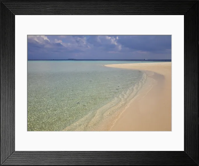 Framed Print : Pristine shallow waters lap against the white coral sand of a tropical beach; Havodda Island, Gaafu Dhaalu atoll, Maldives Framed Print : Pristine shallow waters lap against the white coral sand of a tropical beach; Havodda Island, Gaafu Dhaalu atoll, Maldives