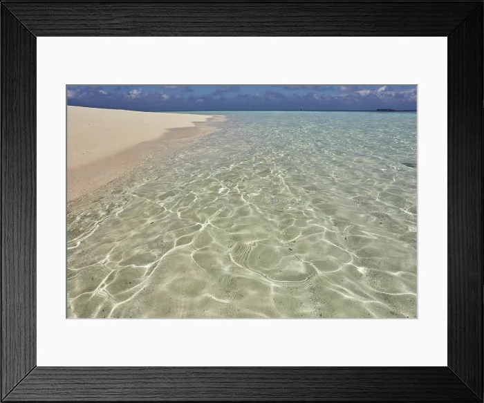 Framed Print : Pristine shallow waters lap against the white coral sand of a tropical beach; Havodda Island, Gaafu Dhaalu atoll, Maldives Framed Print : Pristine shallow waters lap against the white coral sand of a tropical beach; Havodda Island, Gaafu Dhaalu atoll, Maldives