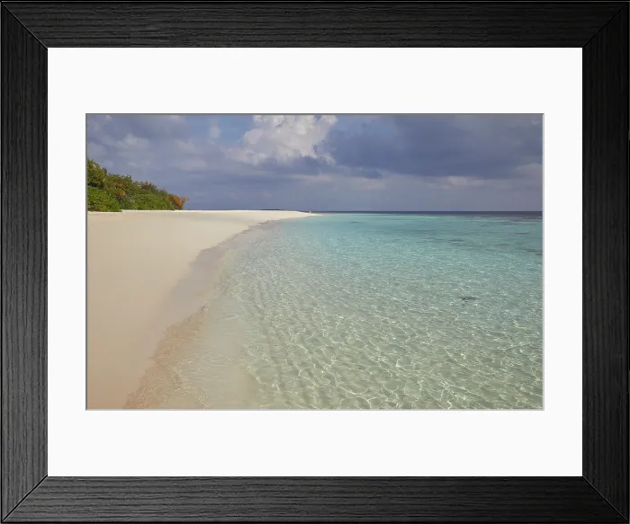 Framed Print : Pristine shallow waters lap against the white coral sand of a tropical beach; Havodda Island, Gaafu Dhaalu atoll, Maldives Framed Print : Pristine shallow waters lap against the white coral sand of a tropical beach; Havodda Island, Gaafu Dhaalu atoll, Maldives