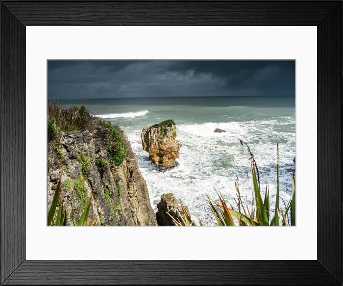 Framed Print : Isolated Limestone Stack and Windswept Vegetation Overlooking Rough Sea at Pancake Rocks, Punakaiki, New Zealand Framed Print : Isolated Limestone Stack and Windswept Vegetation Overlooking Rough Sea at Pancake Rocks, Punakaiki, New Zealand