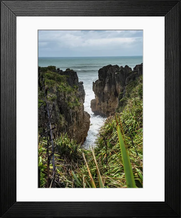 Framed Print : Vertical View of Towering Limestone Cliffs and Deep Ocean Channel at Punakaiki, West Coast, New Zealand Framed Print : Vertical View of Towering Limestone Cliffs and Deep Ocean Channel at Punakaiki, West Coast, New Zealand
