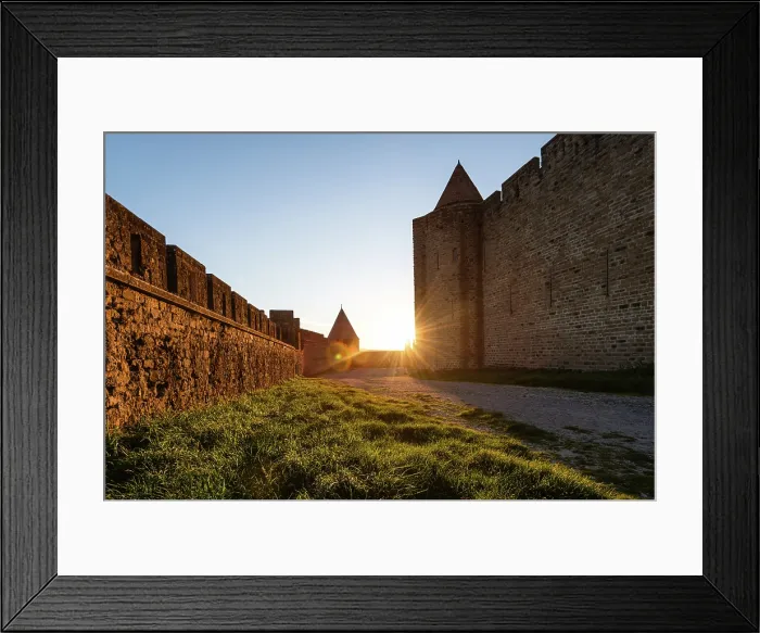 Framed Print : Golden Sunburst Framed by the Towering Stone Fortifications of Carcassonne at Dusk Along a Medieval Path Framed Print : Golden Sunburst Framed by the Towering Stone Fortifications of Carcassonne at Dusk Along a Medieval Path
