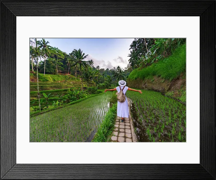 Framed Print : Cheerful woman with arms outstretched standing on footpath amidst paddy fields, Ubud, Bali, Indonesia Framed Print : Cheerful woman with arms outstretched standing on footpath amidst paddy fields, Ubud, Bali, Indonesia