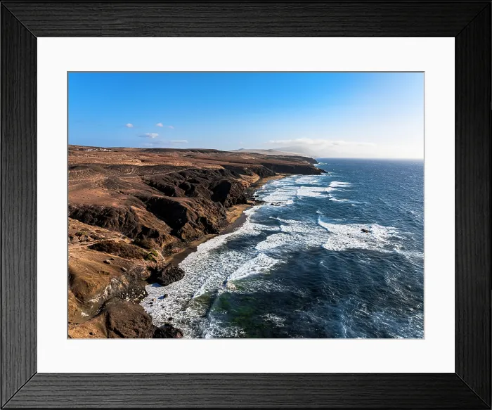 Framed Print : Aerial view of volcanic landscape surrounding La Pared beach washed by waves at sunset, Fuerteventura, Canary Islands, Spain Framed Print : Aerial view of volcanic landscape surrounding La Pared beach washed by waves at sunset, Fuerteventura, Canary Islands, Spain