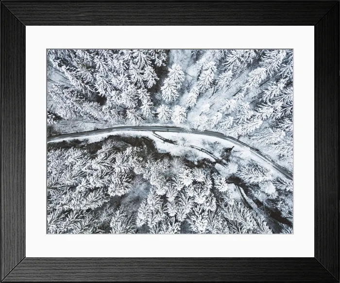 Framed Print : Road in snow covered forest, top down aerial view Framed Print : Road in snow covered forest, top down aerial view