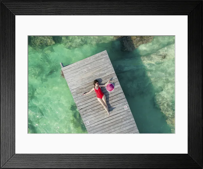 Framed Print : Aerial view of woman laying on wooden pier at sunny summer day in Cancun, Mexico, top view. Young sexy woman in red swimsuit in summertime in Caribbean Framed Print : Aerial view of woman laying on wooden pier at sunny summer day in Cancun, Mexico, top view. Young sexy woman in red swimsuit in summertime in Caribbean