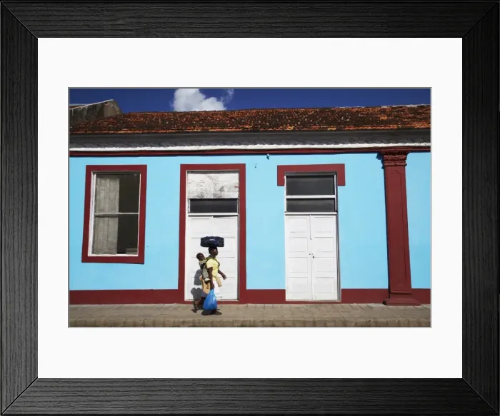 Framed Print : Woman walking past colourful house, Inhambane, Mozambique, Africa Framed Print : Woman walking past colourful house, Inhambane, Mozambique, Africa