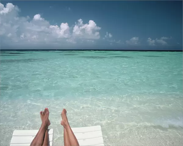 Couples legs on a beach, Maldives, Indian Ocean, Asia