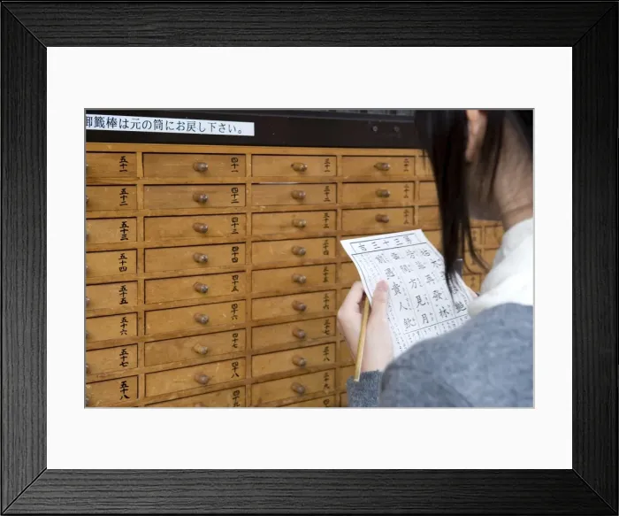 Framed Print : A girl reads her omikuji (paper oracle) at Sensoji Temple in Asakusa, Tokyo, Japan, Asia Framed Print : A girl reads her omikuji (paper oracle) at Sensoji Temple in Asakusa, Tokyo, Japan, Asia