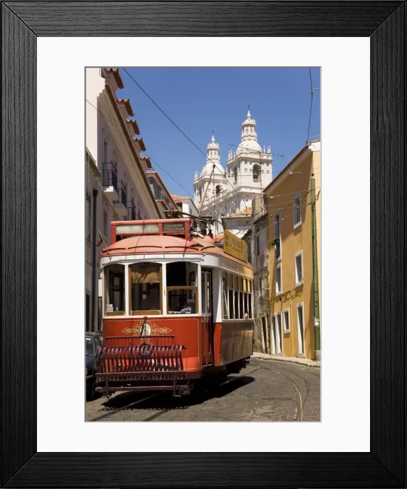 Framed Print : A tram runs along the tourist friendly Number 28 route in Alfama, Lisbon Framed Print : A tram runs along the tourist friendly Number 28 route in Alfama, Lisbon
