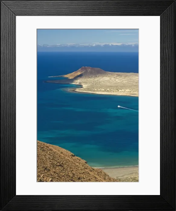 Framed Print : Volcanic cinder cone on Graciosa Island and the Graciosa to Lanzarote ferry in the Rio strait Framed Print : Volcanic cinder cone on Graciosa Island and the Graciosa to Lanzarote ferry in the Rio strait
