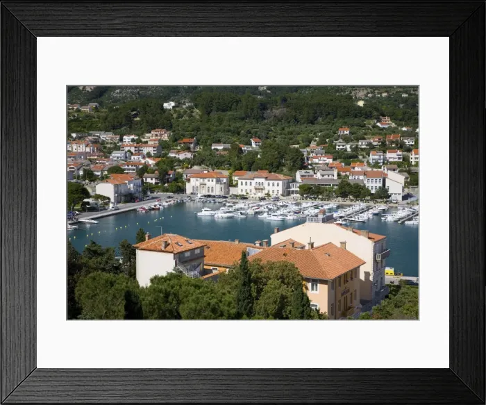 Framed Print : View from hillside across colourful tiled rooftops to the harbour, Rab Town Framed Print : View from hillside across colourful tiled rooftops to the harbour, Rab Town