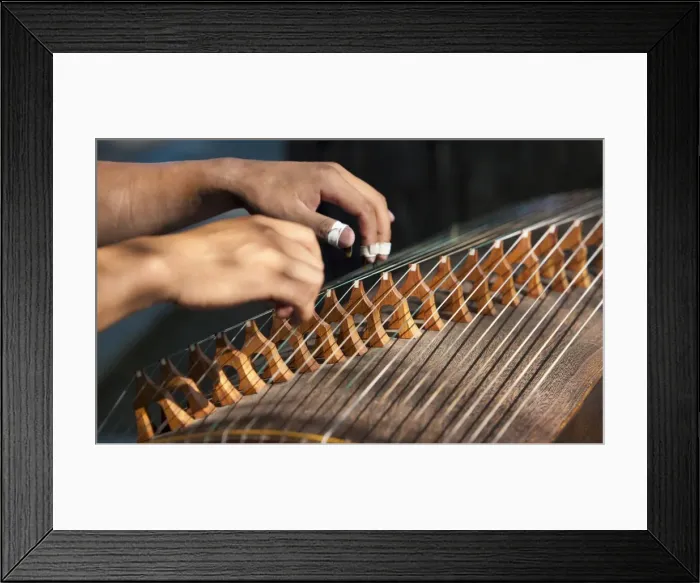 Framed Print : Closeup of two hands playing the guzheng, a traditional Chinese string instrument Framed Print : Closeup of two hands playing the guzheng, a traditional Chinese string instrument