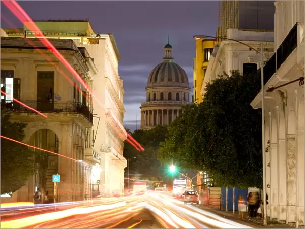 View towards the Capitolio at dusk with light trails of traffic on a busy street