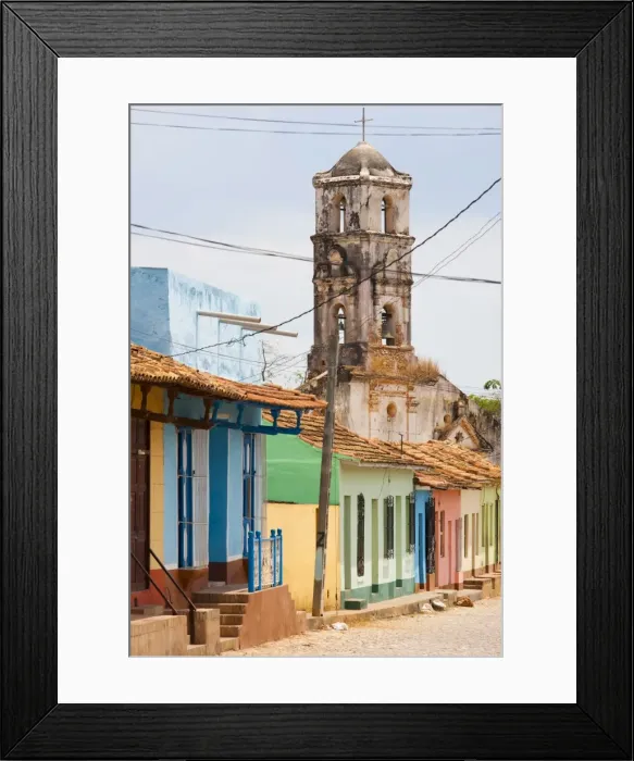 Framed Print : Street scene showing houses painted in bright colours and the ruins of an old church Framed Print : Street scene showing houses painted in bright colours and the ruins of an old church