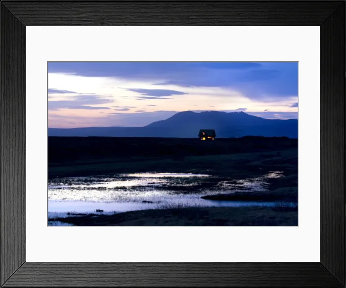Framed Print : Twilight view towards mountains with small house illuminated by interior lights Framed Print : Twilight view towards mountains with small house illuminated by interior lights