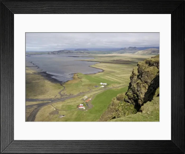 Framed Print : View down to the coast at Dyrholaey showing isolated farms and distant mountains Framed Print : View down to the coast at Dyrholaey showing isolated farms and distant mountains