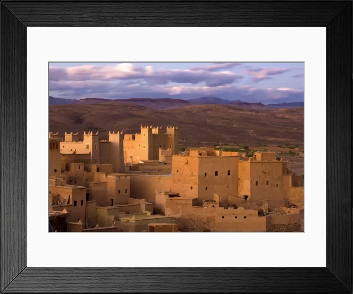 Framed Print : Kasbahs (fortified houses) bathed in evening sunlight with the Jbel Sarhro Mountains in the distance, Nkob, southern Morocco, Morocco, North Framed Print : Kasbahs (fortified houses) bathed in evening sunlight with the Jbel Sarhro Mountains in the distance, Nkob, southern Morocco, Morocco, North