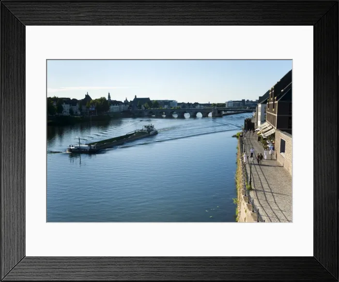 Framed Print : Barge on the River Ms, St. Servatius Bridge and coffee bars at Mspuntweg riverfront Framed Print : Barge on the River Ms, St. Servatius Bridge and coffee bars at Mspuntweg riverfront