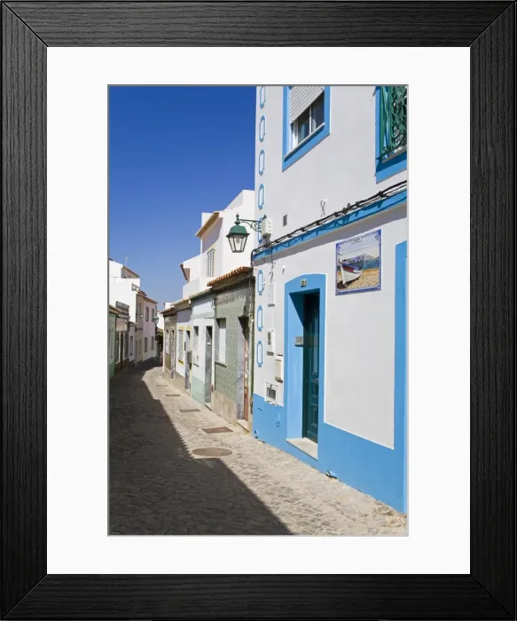 Framed Print : Narrow street in Ferragudo fishing village, Portimao City, Algarve, Portugal, Europe Framed Print : Narrow street in Ferragudo fishing village, Portimao City, Algarve, Portugal, Europe