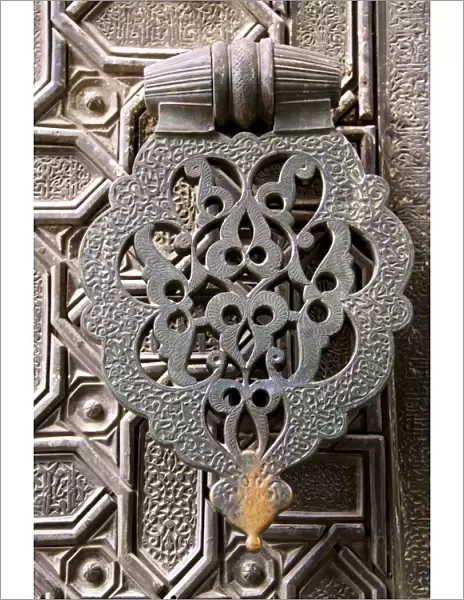 Bronze knocker on wooden engraved doors, Reales Alcazares, Seville, Andalucia