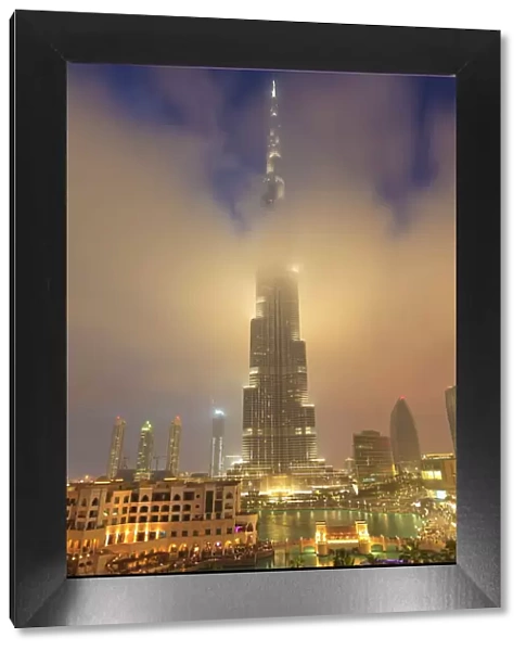 Burj Khalifa illuminates the clouds and surrounding skyline at night, Downtown