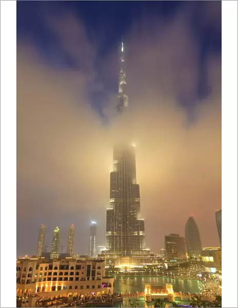 Burj Khalifa illuminates the clouds and surrounding skyline at night, Downtown