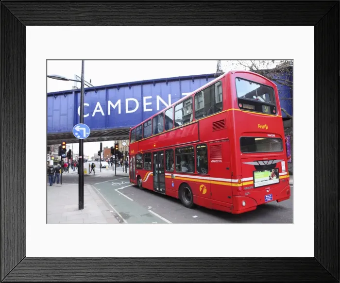 Framed Print : A red double decker bus drives towards the Camden Town area of London, England Framed Print : A red double decker bus drives towards the Camden Town area of London, England