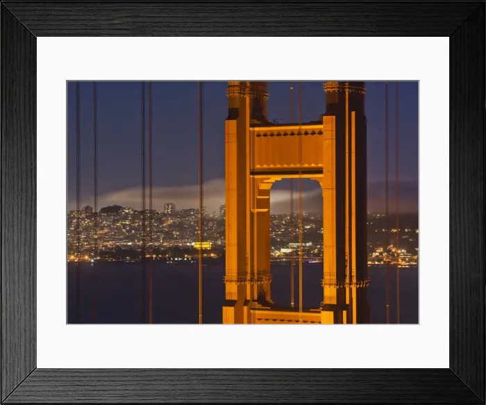 Framed Print : Closeup view of the north tower of the Golden Gate Bridge at sunset with the San Francisco city skyline, San Francisco, California, United States of America Framed Print : Closeup view of the north tower of the Golden Gate Bridge at sunset with the San Francisco city skyline, San Francisco, California, United States of America