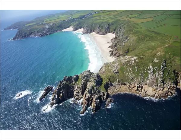 Aerial photo of Treen Cliff and Porthcurno beach looking west to the Minnack Theatre