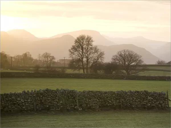 Sunset over Lakeland Fells with fields and stone walls, near Keswick, Lake District National Park