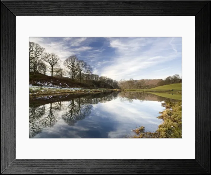 Framed Print : River Brathay on a calm winters day with reflections of trees and distant fells Framed Print : River Brathay on a calm winters day with reflections of trees and distant fells