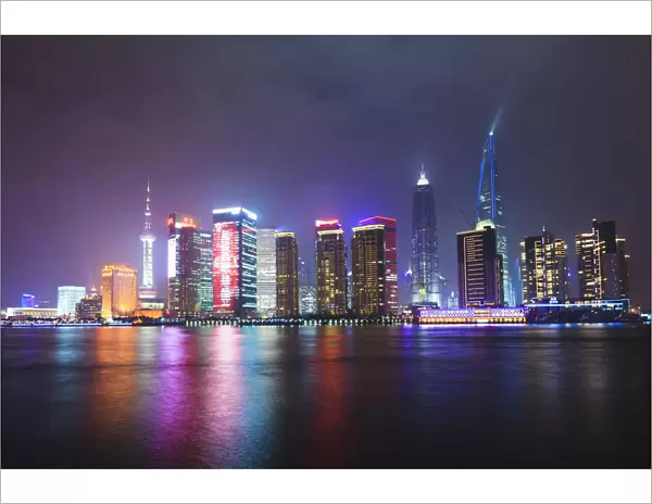 Pudong skyline at night across the Huangpu River, Shanghai, China, Asia