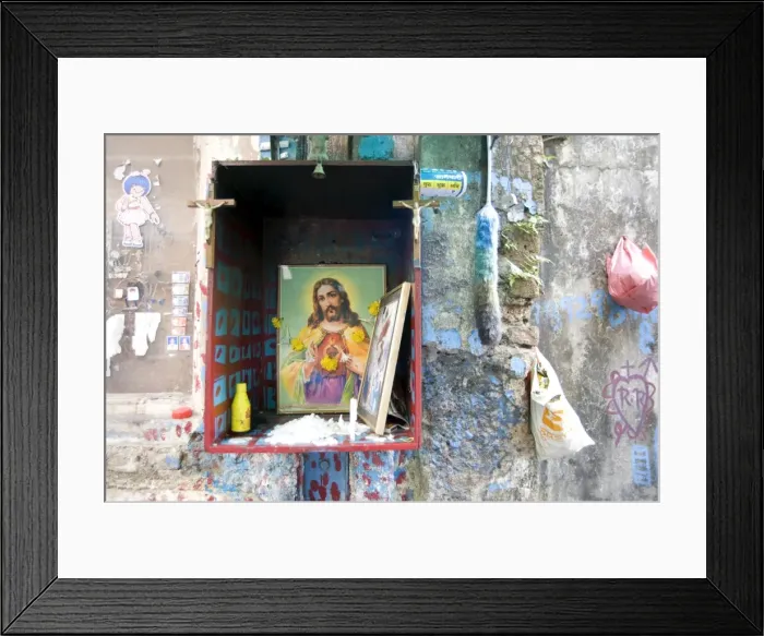Framed Print : Christian shrine in wooden box on a street wall, with candle, marigolds and offerings Framed Print : Christian shrine in wooden box on a street wall, with candle, marigolds and offerings