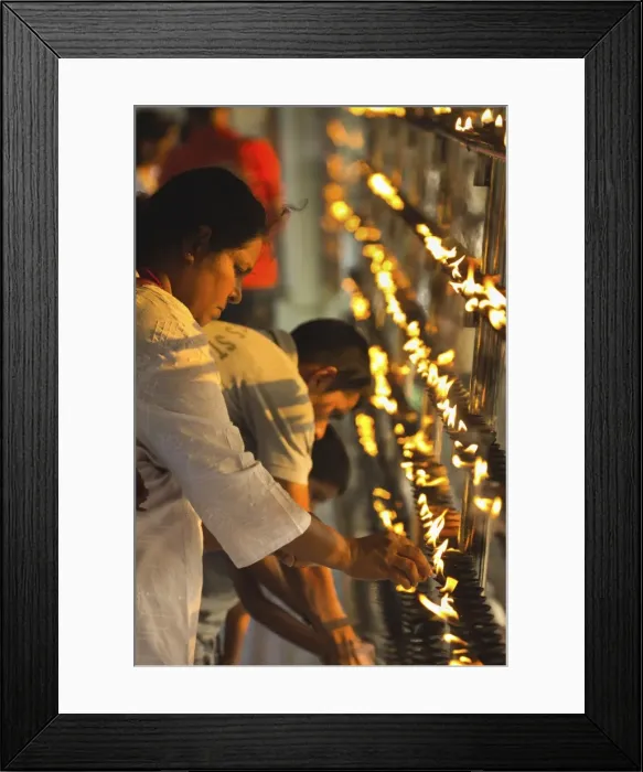 Framed Print : Devotee lighting candles at sunset in the Temple of the Sacred Tooth Relic Framed Print : Devotee lighting candles at sunset in the Temple of the Sacred Tooth Relic