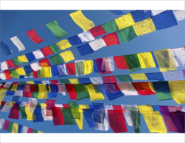 Colourful prayer flags against clear blue sky at Bodhnath Stupa (Boudhanth) (Boudha)