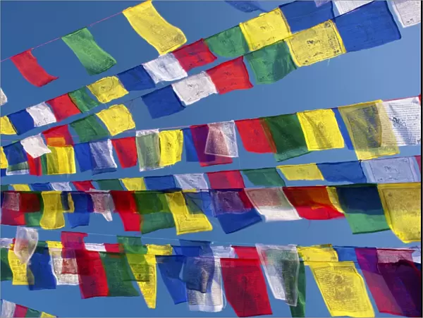 Colourful prayer flags against clear blue sky at Bodhnath Stupa (Boudhanth) (Boudha)